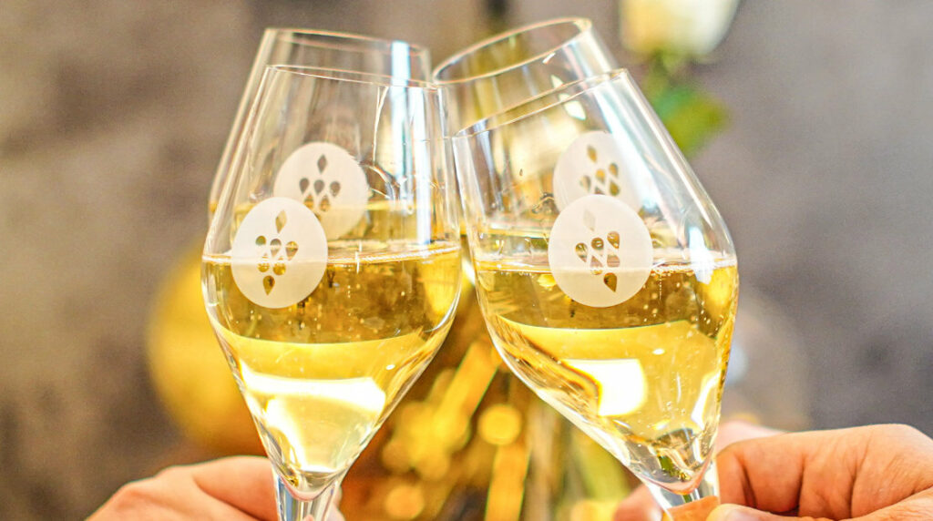 vier Sektgläser werden angestoßen